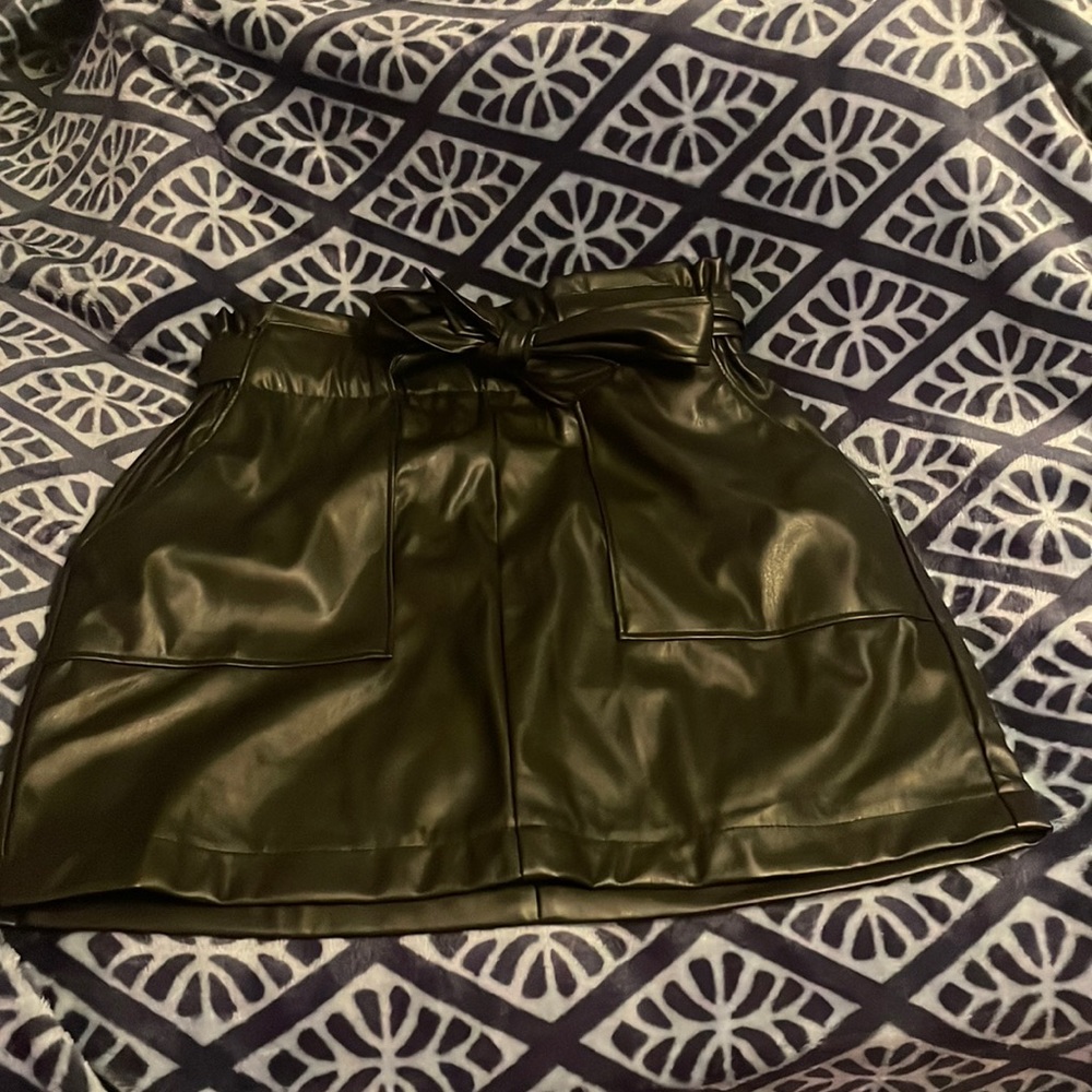 Medium length black small leather skirt